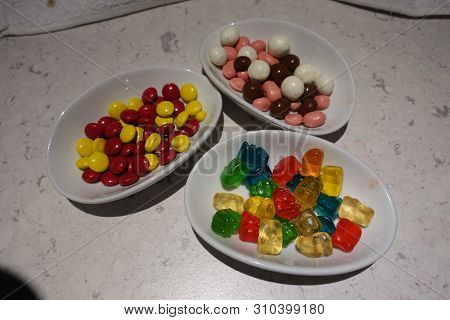 Tasty Bowls Of Gummy Bears, Malted Milk Balls, Chocolate Balls And M&m Type Chocolate Button Candies