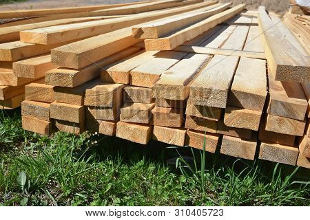 Stacked Lumber. Folded Wood.closeup Wooden Boards.the Surface Of The End Of The Board.lots Of Planks