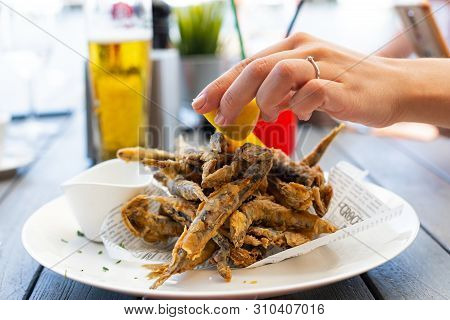 Crispy Fried Black Sea Anchovies (hamsi) With Lemon And Garlic Sauce At The Romanian Seaside