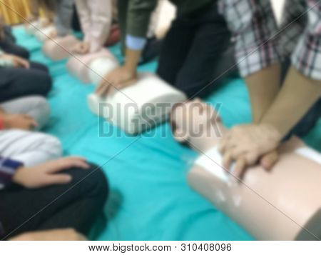 Blurred People Traning On Cpr Course For Saving Another Life In Emergency Case.