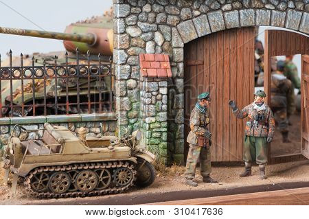 Two German Officers Conversation In Front Of European Yard. World War 2 Time. Miniature