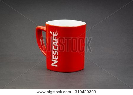 Kuala Lumpur, Malaysia - July 03, 2019; Promotional Red Nescafe Mug On Dark Background. Selective Fo