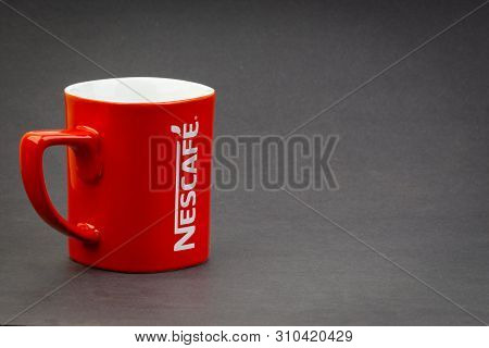 Kuala Lumpur, Malaysia - July 03, 2019; Promotional Red Nescafe Mug On Dark Background. Selective Fo