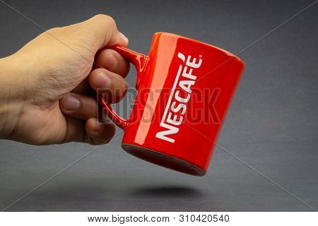 Kuala Lumpur, Malaysia - July 03, 2019; Promotional Red Nescafe Mug On Dark Background. Selective Fo