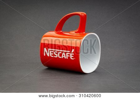 Kuala Lumpur, Malaysia - July 03, 2019; Promotional Red Nescafe Mug On Dark Background. Selective Fo
