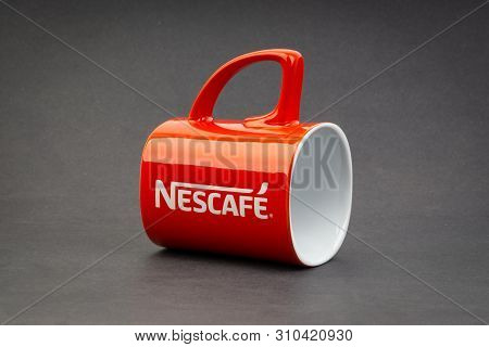 Kuala Lumpur, Malaysia - July 03, 2019; Promotional Red Nescafe Mug On Dark Background. Selective Fo