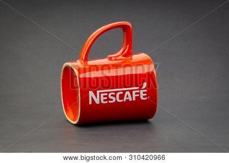 Kuala Lumpur, Malaysia - July 03, 2019; Promotional Red Nescafe Mug On Dark Background. Selective Fo