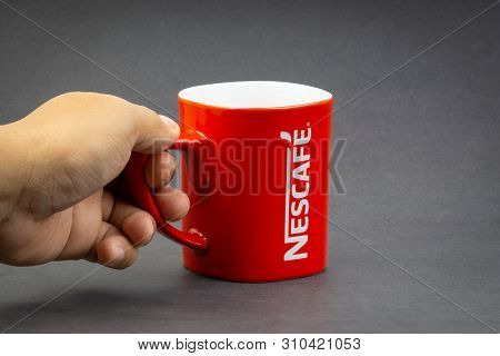 Kuala Lumpur, Malaysia - July 03, 2019; Promotional Red Nescafe Mug On Dark Background. Selective Fo
