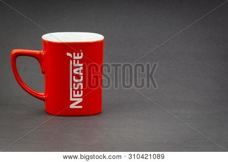 Kuala Lumpur, Malaysia - July 03, 2019; Promotional Red Nescafe Mug On Dark Background. Selective Fo