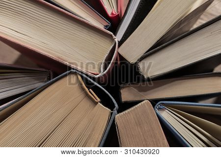 Book In Library With Old Open Textbook, Stack Piles Of Literature Text Archive On Reading Desk, And