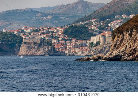 Old Harbour And Fortified Old Town In Dubrovnik, Dalmatia, Croatia. View From Lokrum Island.