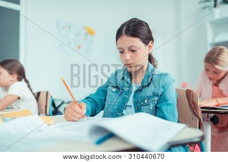 School Girl Looking Anxiously At Her Maths Test.
