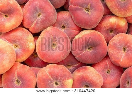 Saturn Peach Or Flat Pan-tao Peach Closeup Background With Full Frame Captured By Peaches