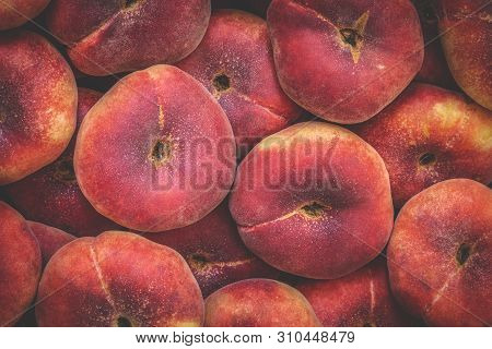 Dounut Peach Or Flat Saturn Peach Closeup Background With Full Frame Captured By Peaches. Toned