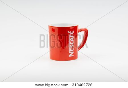 Kuala Lumpur, Malaysia - July 03, 2019:  Promotional Red Nescafe Mug On White Background. Selective 