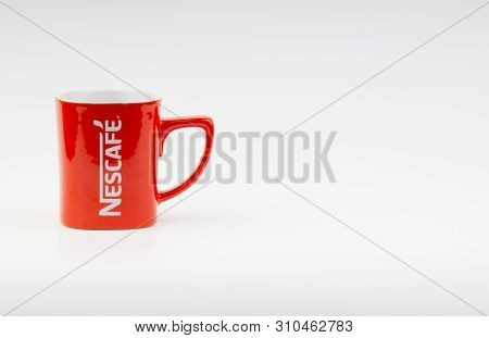 Kuala Lumpur, Malaysia - July 03, 2019:  Promotional Red Nescafe Mug On White Background. Selective 