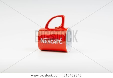 Kuala Lumpur, Malaysia - July 03, 2019:  Promotional Red Nescafe Mug On White Background. Selective 