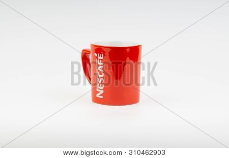 Kuala Lumpur, Malaysia - July 03, 2019:  Promotional Red Nescafe Mug On White Background. Selective 