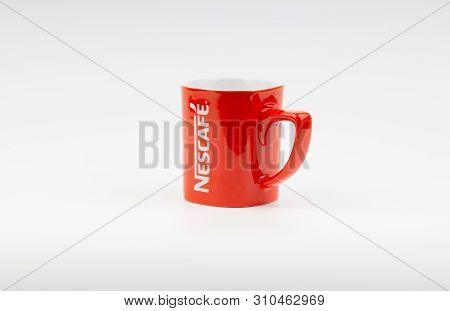Kuala Lumpur, Malaysia - July 03, 2019:  Promotional Red Nescafe Mug On White Background. Selective 