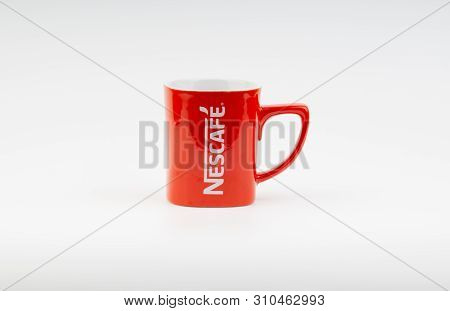 Kuala Lumpur, Malaysia - July 03, 2019:  Promotional Red Nescafe Mug On White Background. Selective 