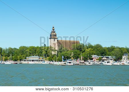 Naantali, Finland - 28 June, 2019: View From The Sea Of Naantali Harbor And Medieval Stone Church At