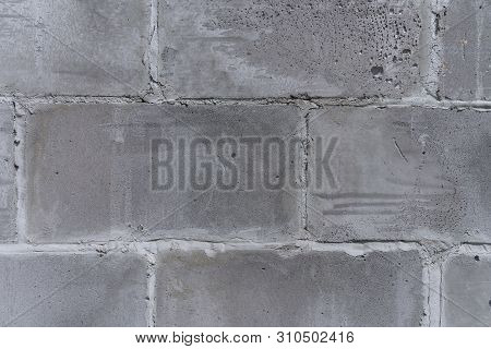 The Wall Of The Old City, Built Of Concrete, Gray, Porous, Shabby Blocks (texture Fragment)