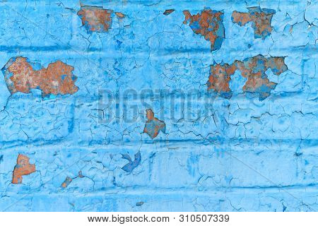 Old Grunge Brick Wall Of A Background Or Texture Painted In Blue Paint That Cracked Under The Influe