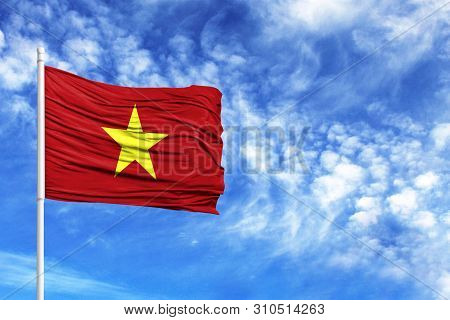 National Flag Of Vietnam On A Flagpole In Front Of Blue Sky
