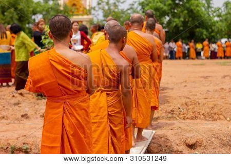 There Was A Merit Making In The Morning. People Would Scoop Food Into The Alms Of Many Monks.