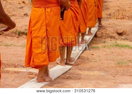 There Was A Merit Making In The Morning. People Would Scoop Food Into The Alms Of Many Monks.