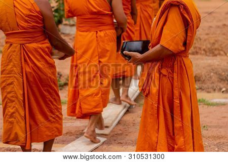 There Was A Merit Making In The Morning. People Would Scoop Food Into The Alms Of Many Monks.