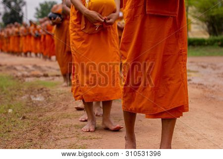 There Was A Merit Making In The Morning. People Would Scoop Food Into The Alms Of Many Monks.