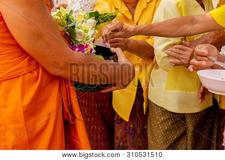 There Was A Merit Making In The Morning. People Would Scoop Food Into The Alms Of Many Monks.