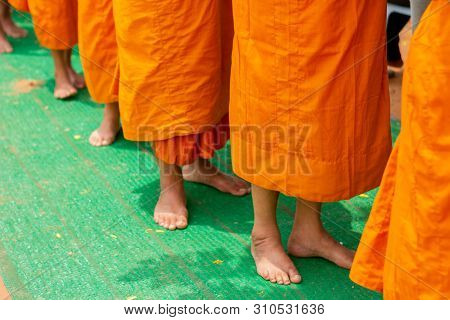 There Was A Merit Making In The Morning. People Would Scoop Food Into The Alms Of Many Monks.