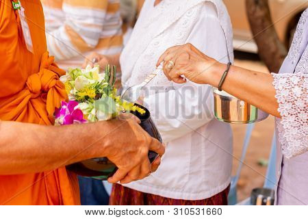 There Was A Merit Making In The Morning. People Would Scoop Food Into The Alms Of Many Monks.
