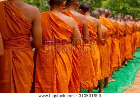 There Was A Merit Making In The Morning. People Would Scoop Food Into The Alms Of Many Monks.