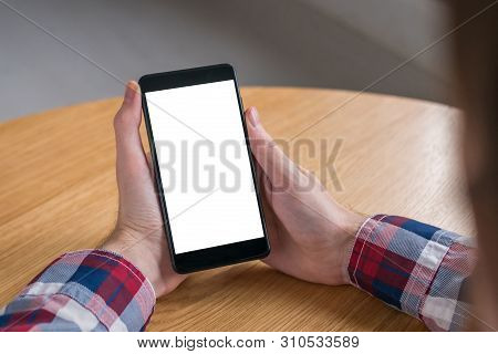 Mock Up, Copyspace, Template And Technology Concept. Man Looking At Black Smartphone With White Blan