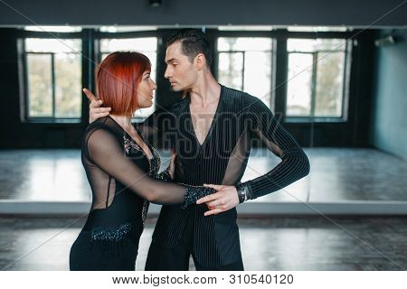Man and woman on ballrom dance training in class