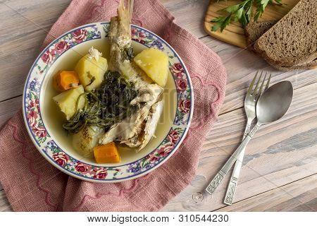 Ready Meals. Fish Soup In A Plate From Grouper (epinephelus Aeneus) On A Wooden Table Close-up