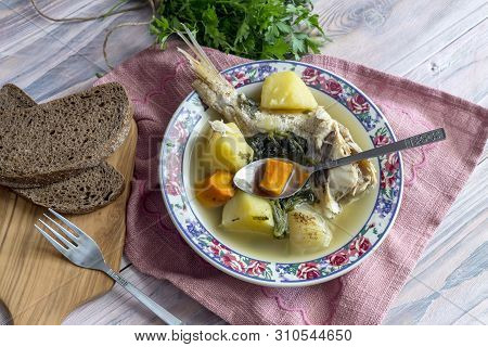 Ready Meals. Fish Soup In A Plate From Grouper (epinephelus Aeneus) On A Wooden Table Close-up