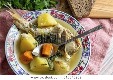 Ready Meals. Fish Soup In A Plate From Grouper (epinephelus Aeneus) On A Wooden Table Close-up