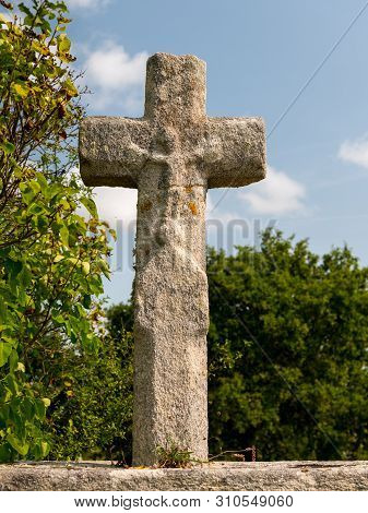 Old Stone Cross With Trees In The Background On A Sunny Day