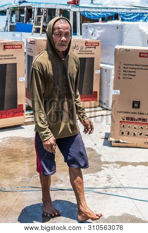 Makassar, Sulawesi, Indonesia - February 28, 2019: Paotere Old Port. Closeup Of Old Dock Worker Walk