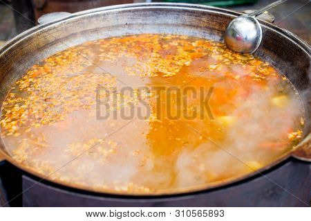 Cooking In A Large Cauldron Oriental Dishes - Soup Soup Large Vegetables And Meat. Shurpa In A Large