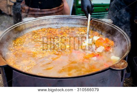 Cooking In A Large Cauldron Oriental Dishes - Soup Soup Large Vegetables And Meat. Shurpa In A Large