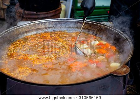 Cooking In A Large Cauldron Oriental Dishes - Soup Soup Large Vegetables And Meat. Shurpa In A Large