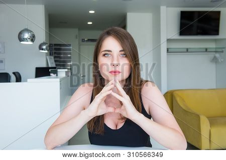 Close Up Portrait Of A Young Confident Serious Woman With Deep Decollete, Looking At The Camera, Hol