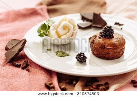 Chocolate Fondan With Syrup And Ice-cream On A Plate Decorated With Mint Leaves.