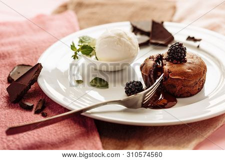 Chocolate Fondan With Syrup And Ice-cream On A Plate Decorated With Mint Leaves.