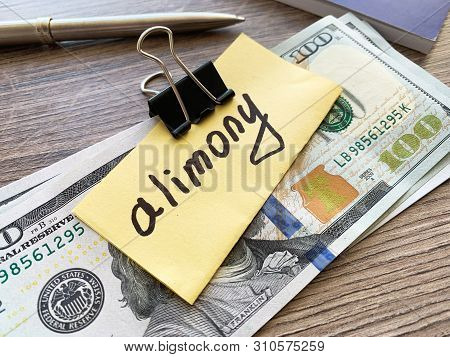 Payments Alimony. Pile Dollars With Sign Alimony And Money. Divorce And Separation Concept